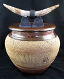 clay pot with horns on lid